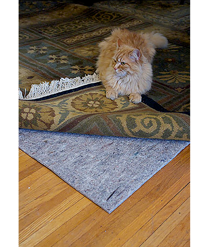 Felt rug pad under an area rug on a hardwood floor